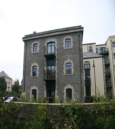 Concrete cutting through blue pennant stone Edward England, Cardiff